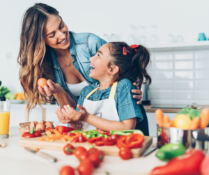 Mother and Daughter in kitchen cooking healthy foods