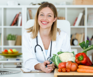 A nutritionist with a stethoscope and veggies