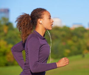 A woman on a run with headphones in 